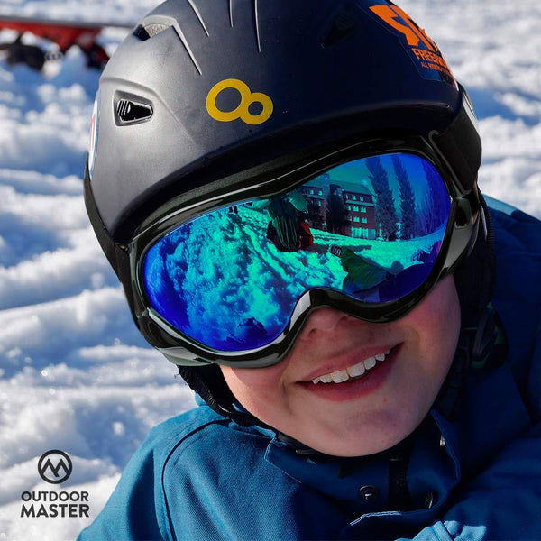 OutdoorMaster Kids Ski Goggles - Helmet Compatible Snow Goggles for Boys & Girls with 100% UV Protection (Black Frame + VLT 15% Grey Lens with Full REVO Blue)